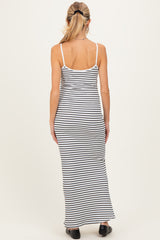woman wearing a black and white striped maternity maxi dress with spaghetti straps, showcasing a fitted silhouette