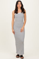 woman wearing a white and black striped sleeveless maxi dress with a fitted silhouette