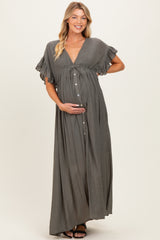 woman wearing a grey maternity maxi dress with short ruffle sleeves and a button-down front, holding her baby bump