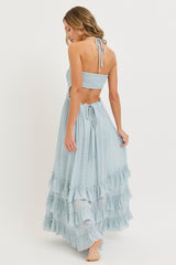 woman wearing a light blue tiered maxi dress with ruffle details and a halter neck, shown from the back