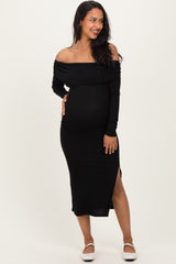 woman wearing a black off-shoulder maternity dress with side slit and holding her baby bump