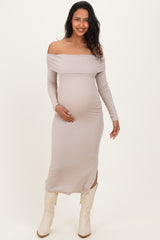 woman wearing a light taupe off-shoulder maternity dress with long sleeves and a visible baby bump
