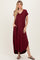 woman wearing a burgundy short sleeve maxi dress with pockets and a v-neckline