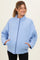 woman wearing a light blue quilted maternity jacket with side pockets and a high collar