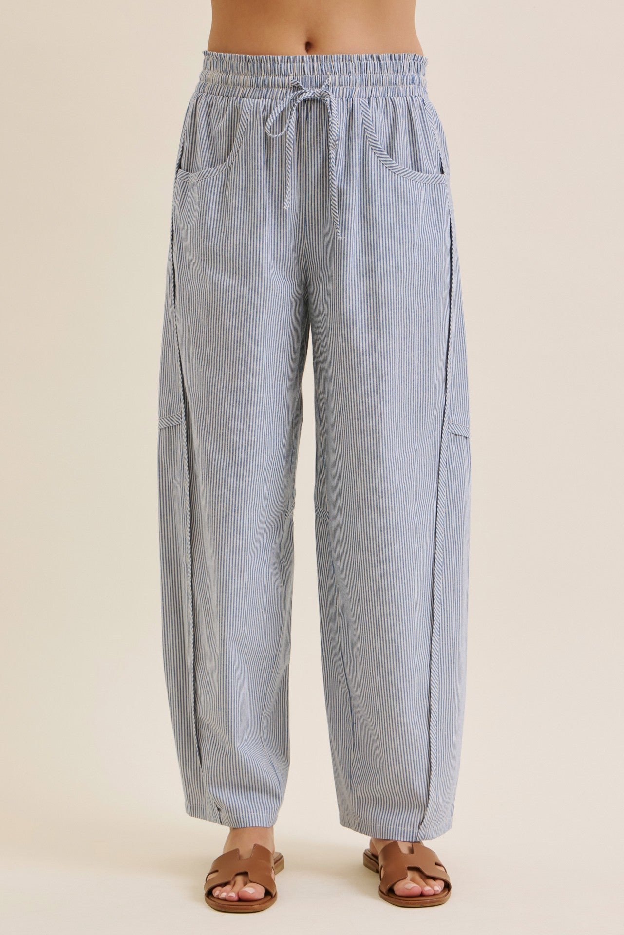 woman wearing blue and white striped loose-fitting pants with an elastic waistband and side pockets
