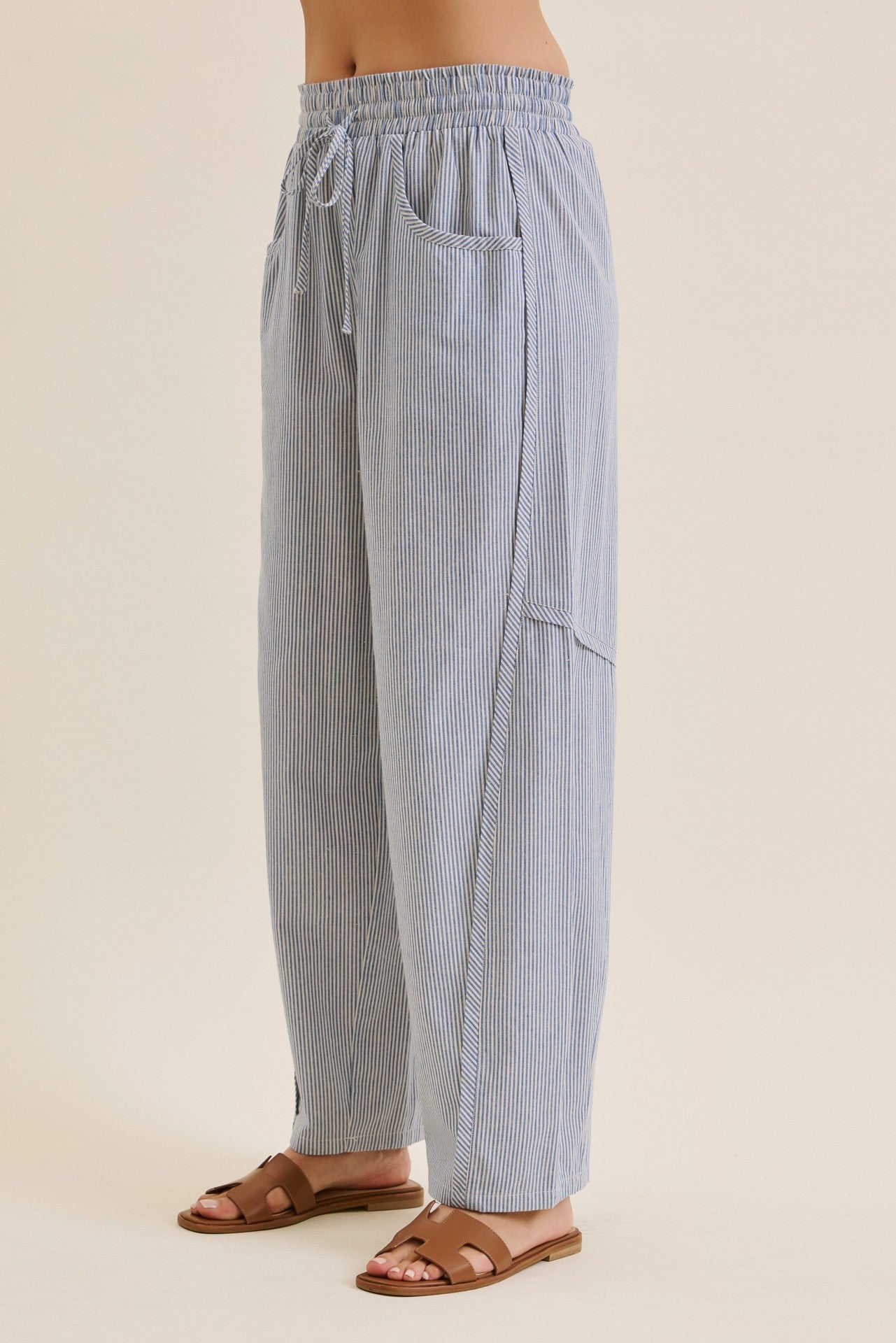 woman wearing blue and white striped wide-leg pants with an elastic waistband and side pockets