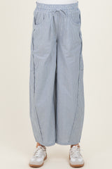 maternity wear striped wide-leg pants with an elastic waistband and side pockets, worn with white sneakers