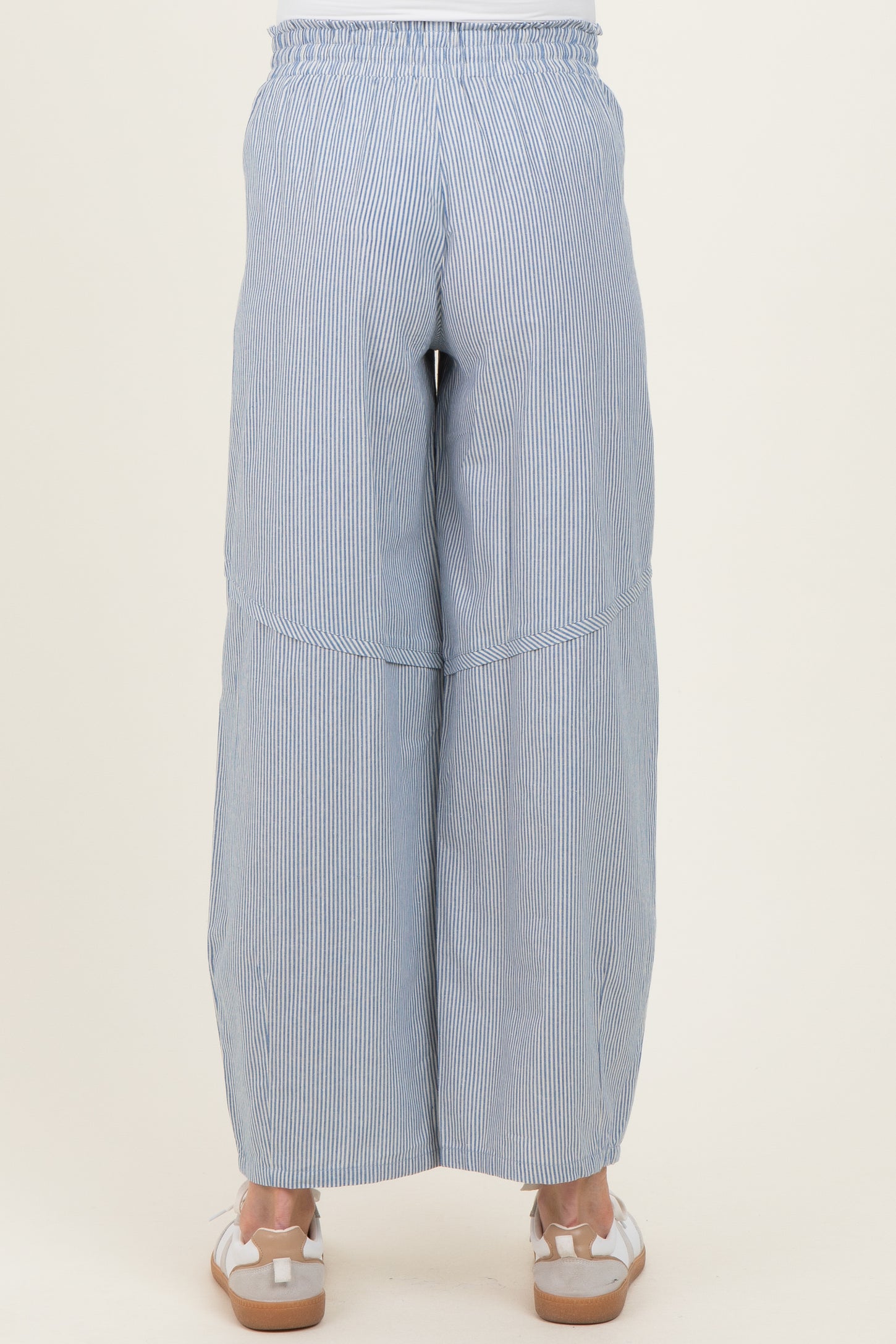 woman wearing navy and white striped maternity wide-leg pants, seen from the back