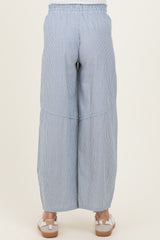 woman wearing navy and white striped maternity wide-leg pants, seen from the back