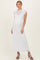 woman wearing a white lace cap sleeve maternity dress with a floor-length hem and a relaxed fit