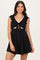 woman wearing a black ruffled sleeve dress with a front tie and cutout details