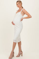 woman wearing a white lace maternity dress with adjustable straps and a visible baby bump