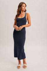 woman wearing a navy blue ribbed midi dress with cream trim and espadrille sandals