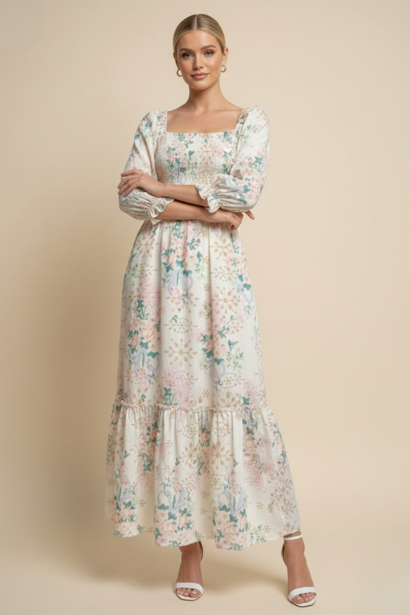 woman wearing a floral long sleeve maxi dress with a square neckline and tiered hem