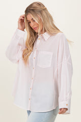woman wearing a lightweight pink button-up shirt with a front pocket and relaxed fit