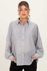 woman wearing a blue and white striped maternity button-up shirt with two front pockets and relaxed fit
