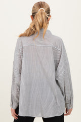 woman wearing a striped maternity shirt featuring a relaxed fit and long sleeves, shown from the back