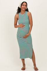 woman wearing a green and white striped maternity maxi dress, highlighting her baby bump