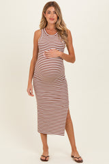 woman wearing a striped maternity maxi dress with a side slit and holding her baby bump