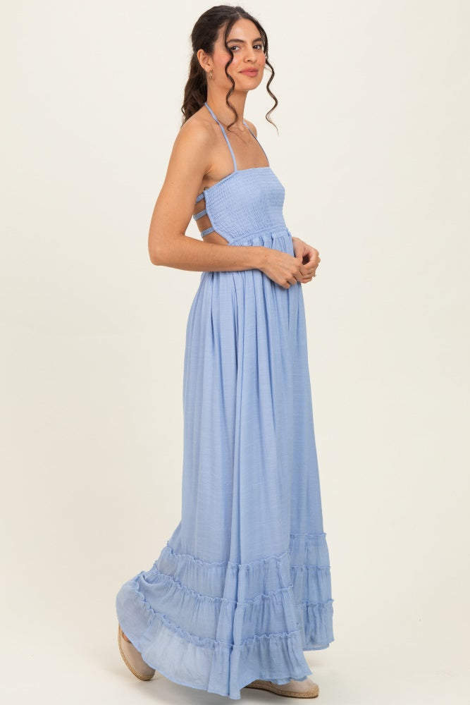 woman wearing a light blue smocked maxi dress with spaghetti straps and tiered ruffle hem