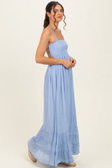 woman wearing a light blue smocked maxi dress with spaghetti straps and tiered ruffle hem