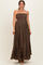 woman wearing a brown strapless maternity maxi dress with a smocked bodice and tiered ruffle hem