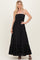 woman wearing a black strapless maxi dress with a smocked bodice and ruffled hem