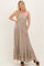 woman wearing a light brown strapless maxi dress with a smocked bodice and tiered ruffle hem