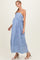 woman wearing a blue and white striped maternity maxi dress with adjustable straps and a flowing skirt, showing her baby bump