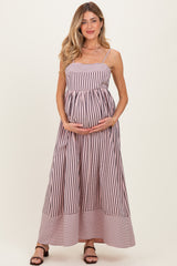 woman wearing a striped maternity maxi dress and holding her baby bump