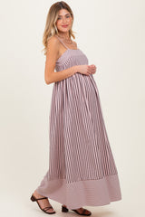 woman wearing a pink and white striped maternity dress with a flowing silhouette and a visible baby bump