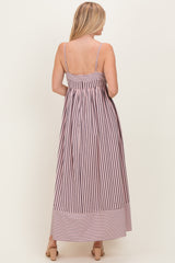 woman wearing a back view of a striped maxi dress with thin straps and a fitted bodice