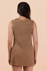 woman wearing a beige sleeveless ribbed knit dress, showing the back view against a light background