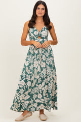 woman wearing a green floral maxi dress with a deep V-neck and a front cutout detailing