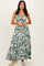 woman wearing a green floral maxi dress with a deep V-neck and a front cutout detailing