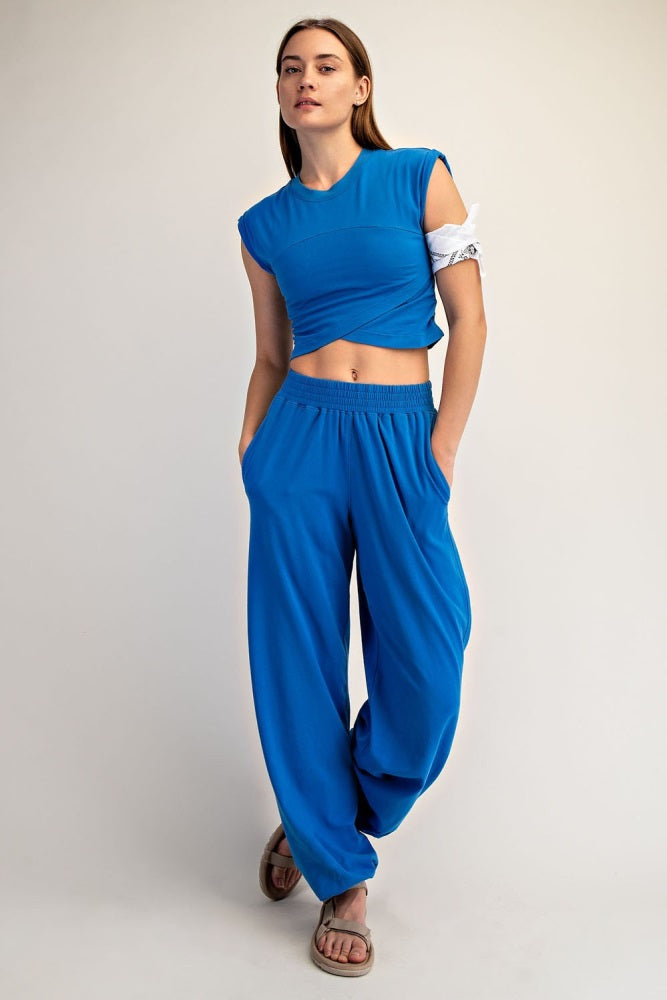 woman wearing a bright blue cropped t-shirt and loose matching pants, styled with a relaxed fit