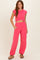 woman wearing a hot pink cropped t-shirt and matching loose-fitting pants with elastic cuffs