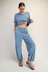 woman wearing a light blue cropped t-shirt and matching relaxed-fit sweatpants