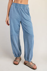 woman wearing light blue relaxed fit sweatpants with an elastic waistband and gathered cuffs