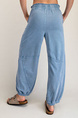 woman wearing light blue baggy sweatpants with a relaxed fit and elastic waistband, shown from the back