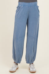 woman wearing blue maternity jogger pants with elastic waistband and relaxed fit