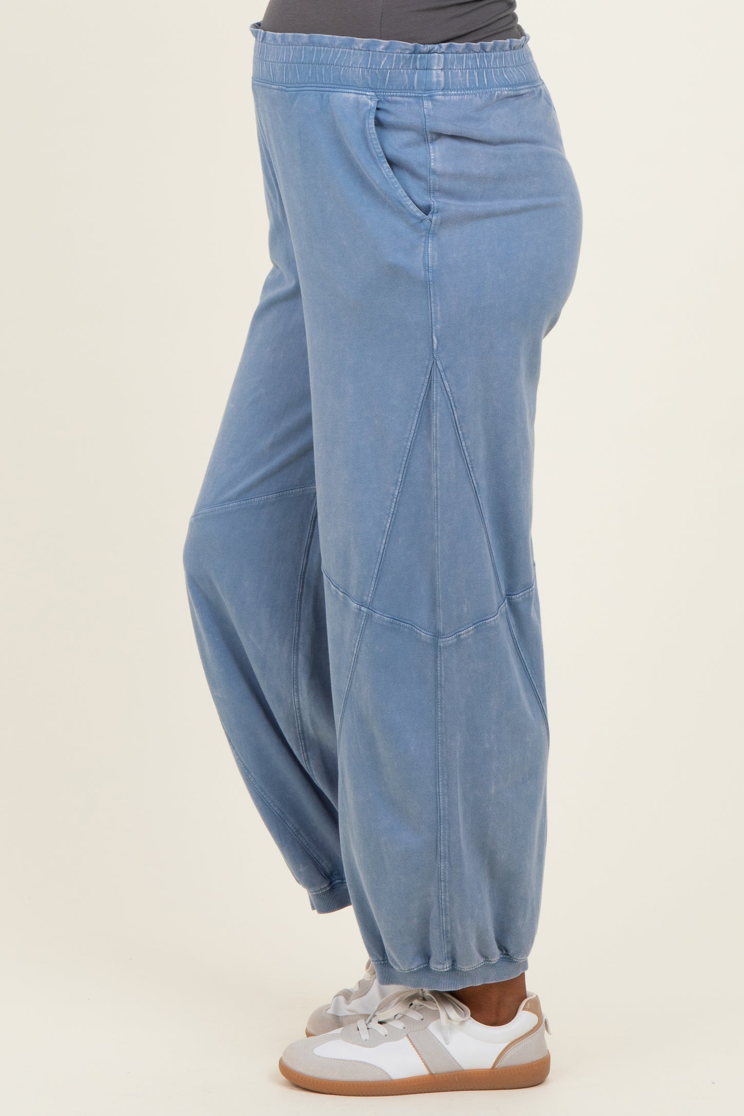 woman wearing light blue maternity jogger pants with side pockets and elastic cuffs