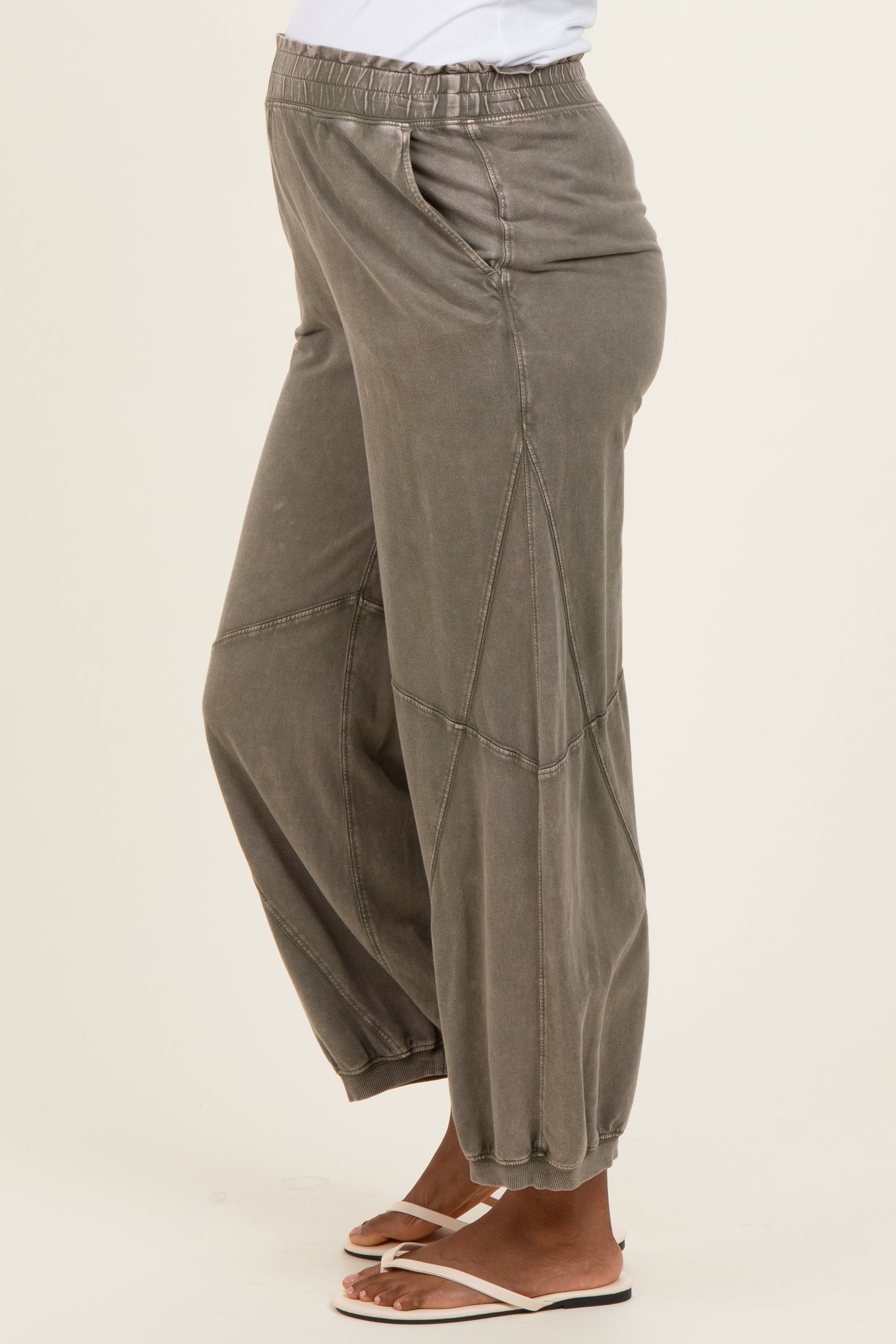 woman wearing gray maternity joggers with an elastic waistband and tapered cuffs