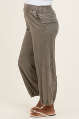 woman wearing gray maternity joggers with an elastic waistband and tapered cuffs
