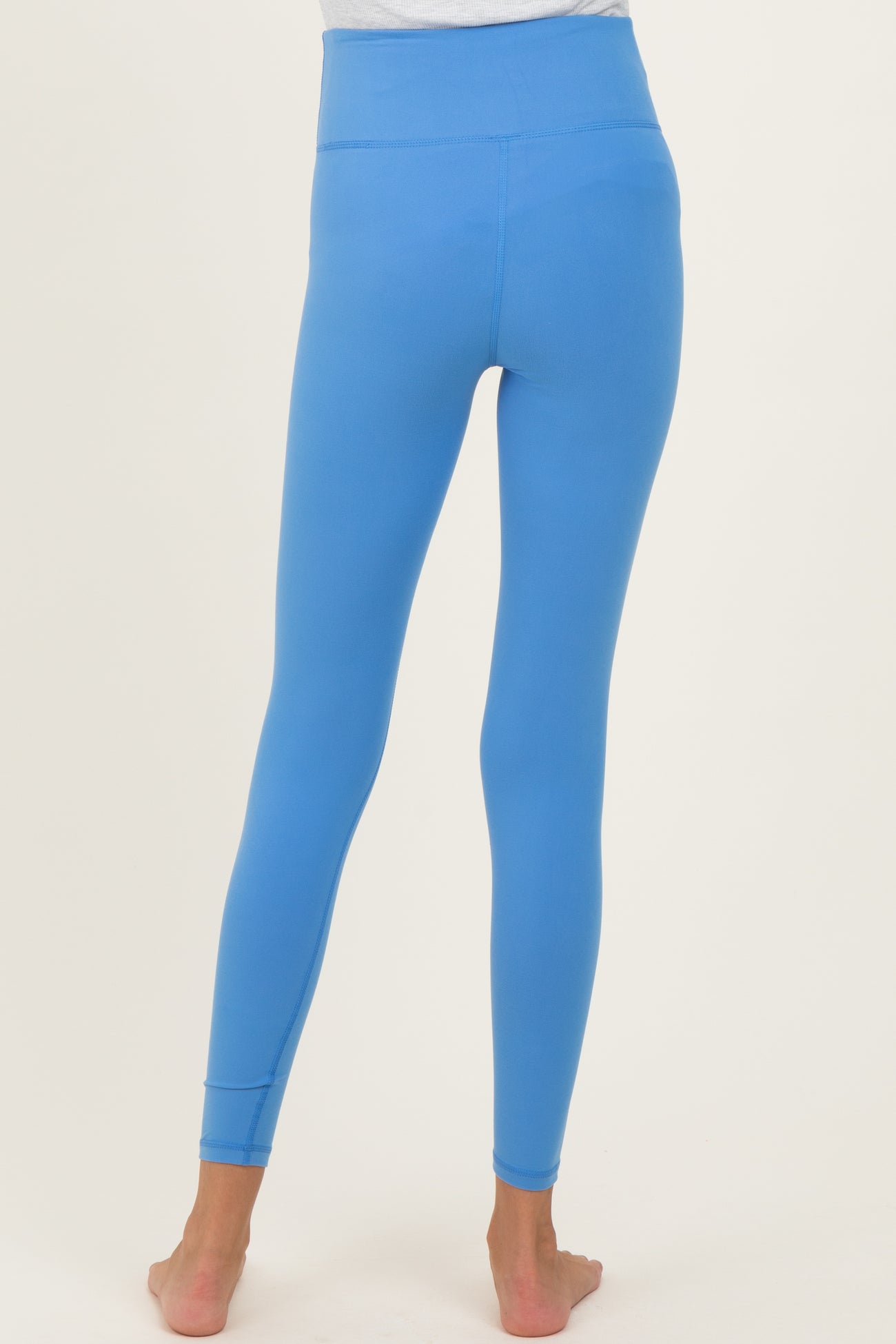 maternity wear in bright blue high-waisted leggings, shown from the back