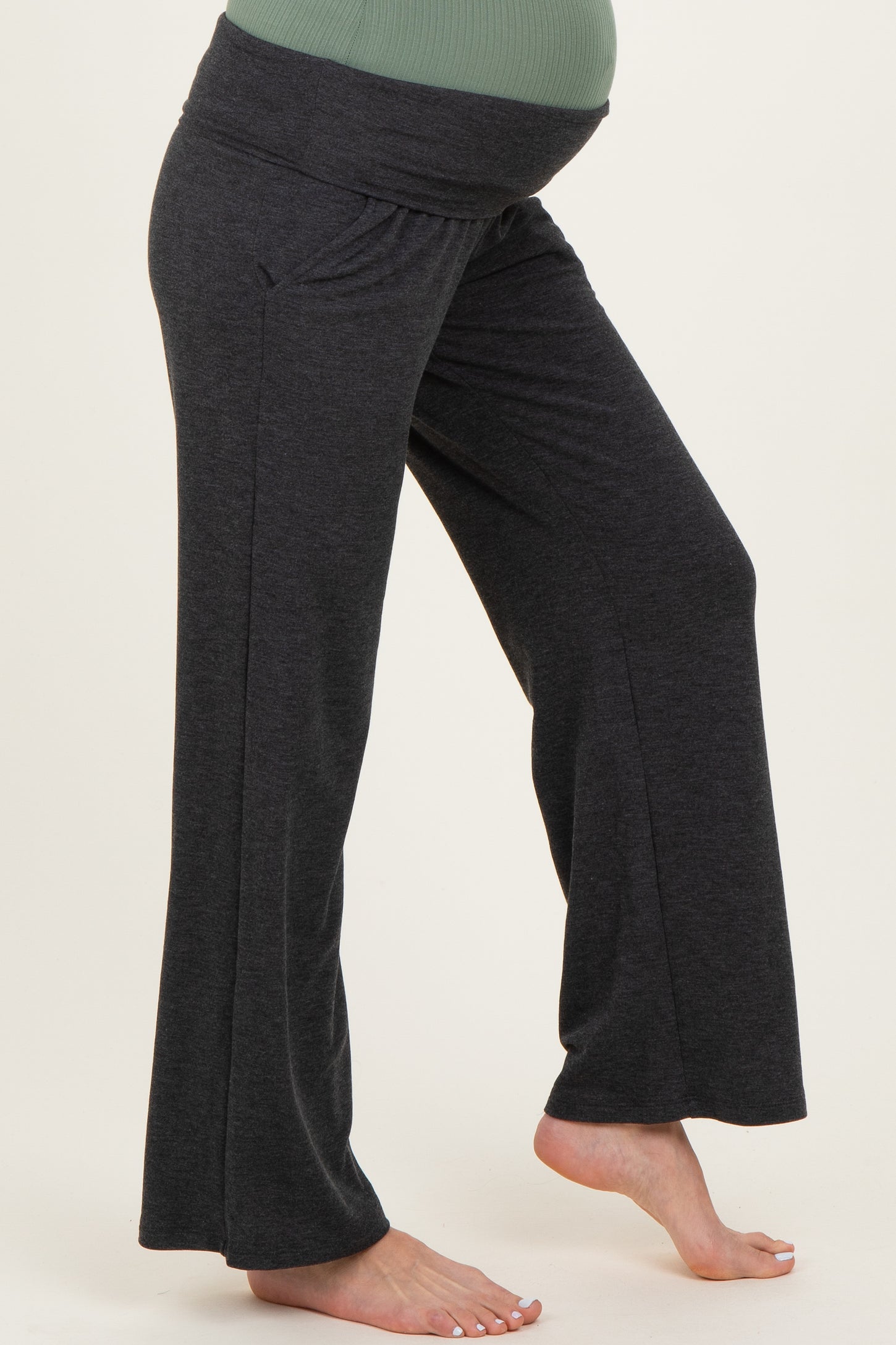 maternity wear in dark gray wide-leg pants with a comfortable waistband and highlighted baby bump