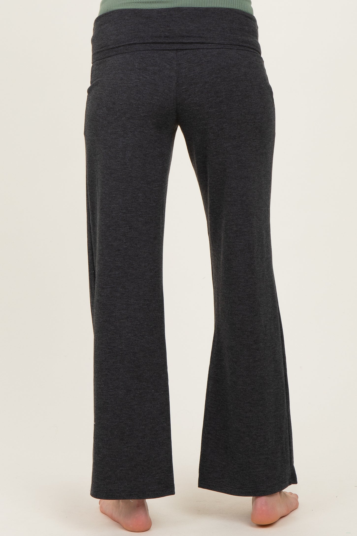woman wearing dark gray maternity pants, showing the back view and stretchy waistband