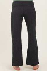 woman wearing dark gray maternity pants, showing the back view and stretchy waistband