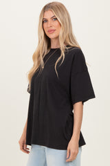 woman wearing a loose black oversized t-shirt paired with light blue jeans