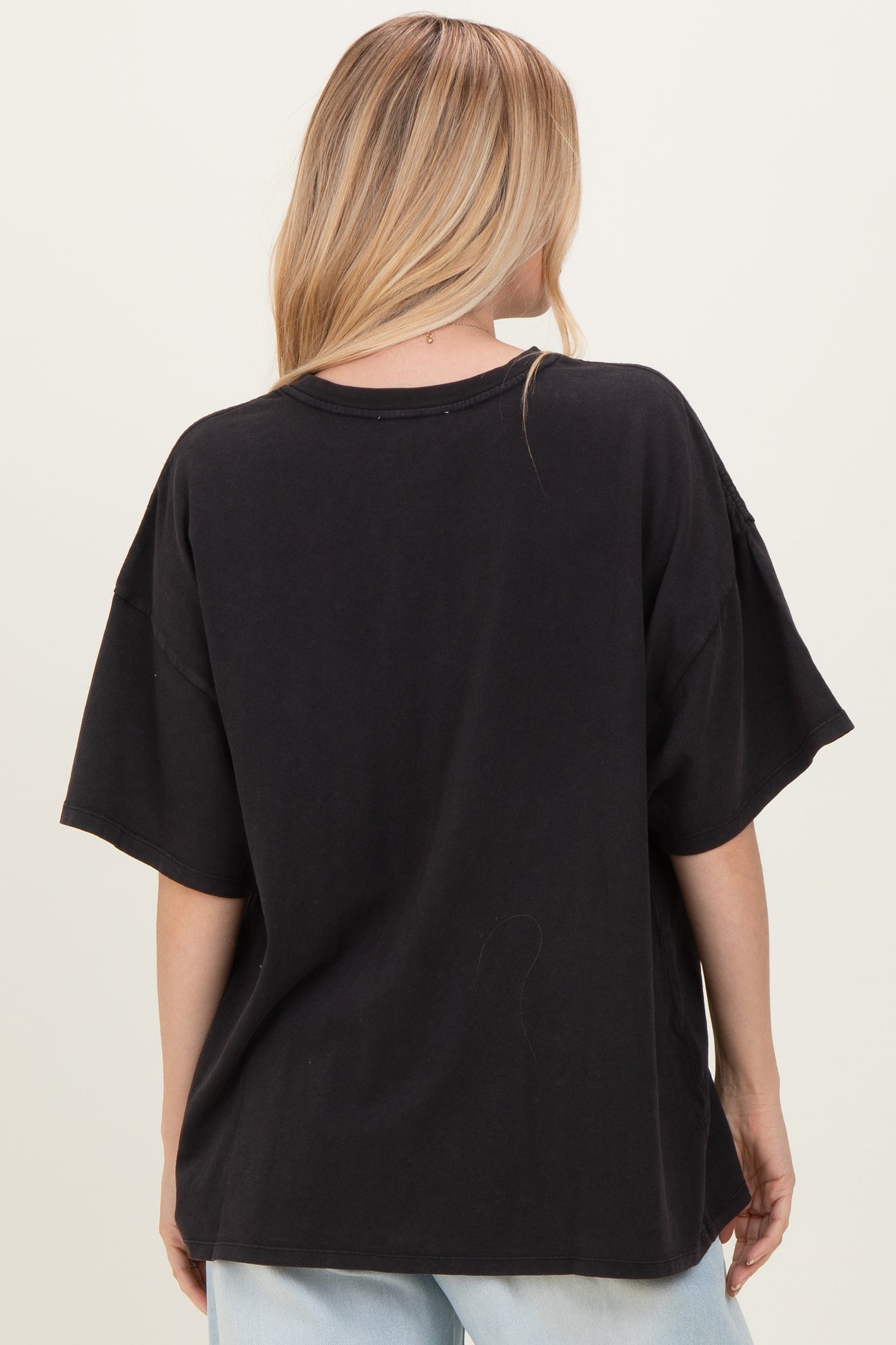 woman wearing a black oversized t-shirt from the back with relaxed sleeves